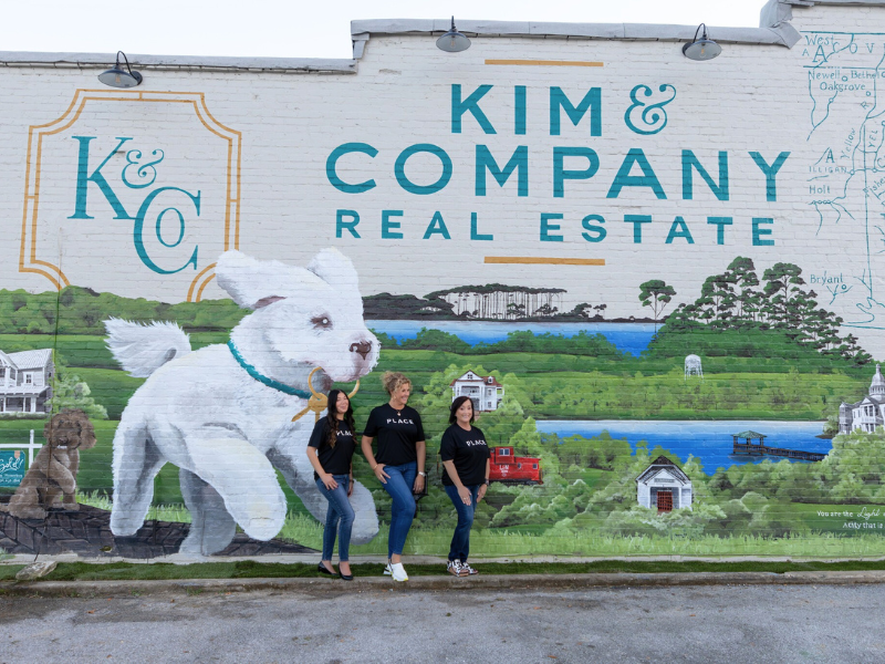 Kim & Company in front of their mural