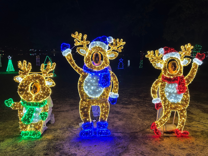 Family posing at Christmas Reflections Decorations.