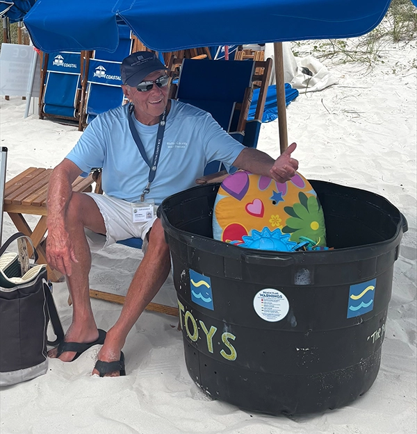 Bobby Watkins and one of his beach buckets with children's beach toys. Bobby Watkins and one of his beach buckets with children's beach toys.